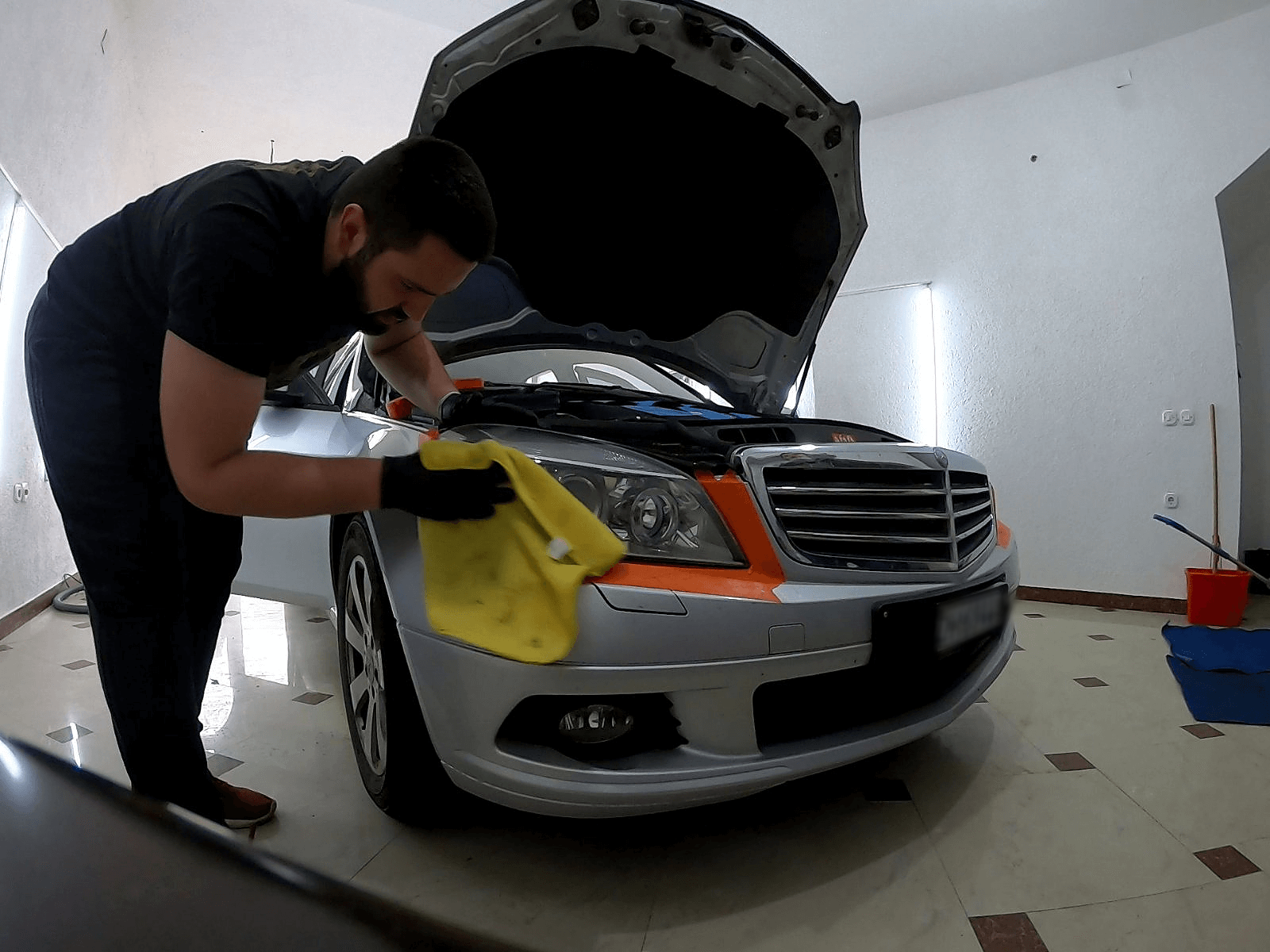 wiping the headlights with paper towel